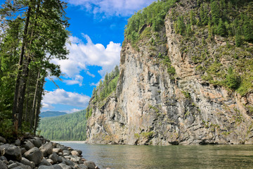 Mountain river landscape in Siberia - stream of a mountain river running between mountains in summer. River Oka Sayan, East Saiyan, Russia.