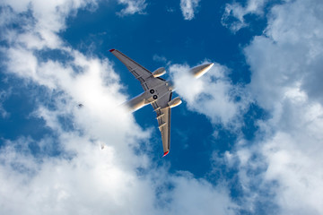 Airplane in the sky among the clouds. Background. Writing area.