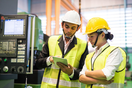 Factory workers check stock in tablet