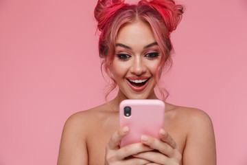 Portrait of seductive shirtless young woman smiling and holding smartphone
