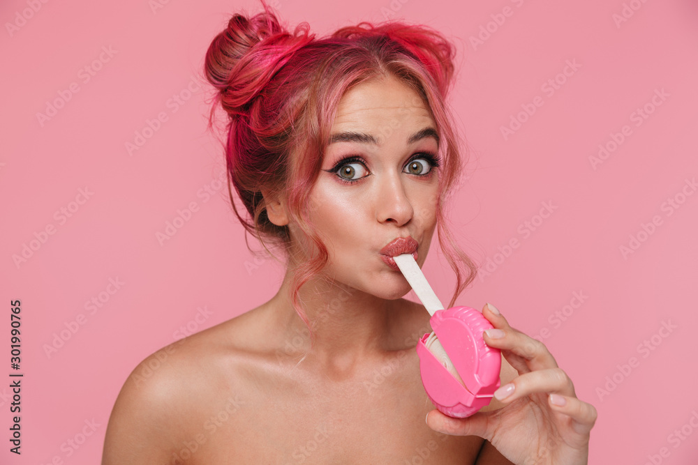 Canvas Prints Portrait of seductive shirtless young woman holding sweet chewing gum