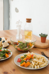 pasta with vegetable salad and cheesecake with berries lunch concept in a cafe. vegetarianism. vegan food