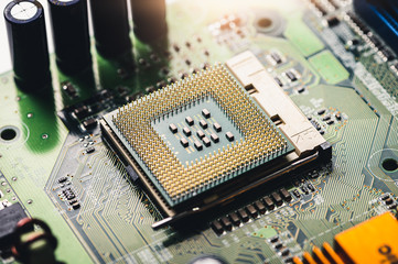 The technician is laying a CPU on the socket of the computer motherboard. the concept of computer,...
