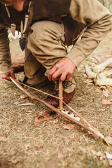 An ancient method of producing fire from improvised materials - the method of friction of a dry...