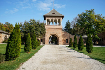 Entrance to the Mogosoaia Palace architectural ensemble , the gate tower and alley in front of it , near Bucharest , Romania