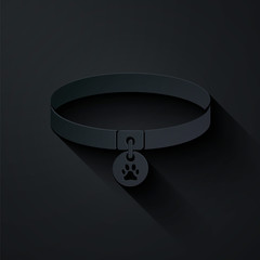 Paper cut Collar with name tag icon isolated on black background. Supplies for domestic animal. Dog or cat paw print. Cat and dog care. Pet chains. Paper art style. Vector Illustration © vector_v