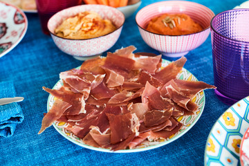 serrano ham on a colorful set table