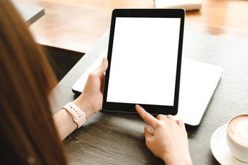 mockup image computer,taplet blank screen for hand typing text,using laptop contact business searching information in workplace on desk at office.design creative work space on wooden desk