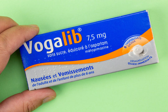 Vogalib box holding in hand with green background