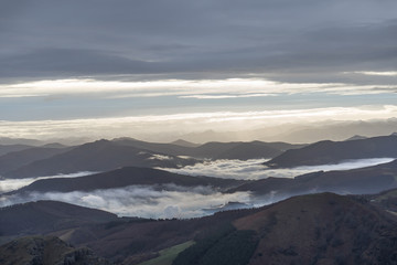 Morning lights in mountais with clouds.