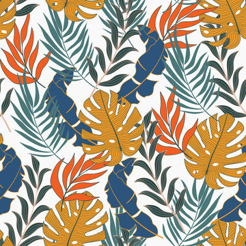 Trend seamless tropical pattern with bright yellow and blue plants and leaves on a light background. Beautiful print with hand drawn exotic plants. Tropic leaves in bright colors.