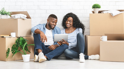 Young woman showing her man on tablet ideas for interior