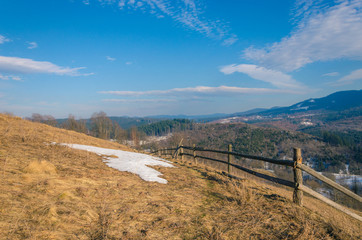 spring in mountains. snow is melting on a hill