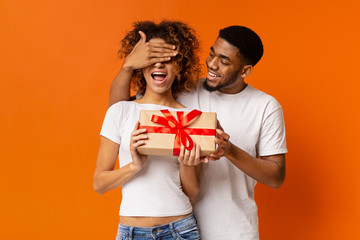 Loving black guy surprising his girlfriend with gift
