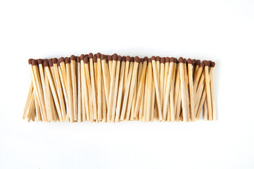 big pile of wooden matches on white background top view