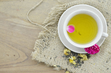 Cup of flower tea on wooden background