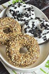 Sweet tasty dessert. Donuts with a hole, white chocolate and nuts.