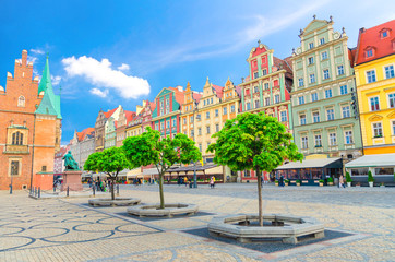 Row of colorful buildings with multicolored facade and Old Town Hall building on cobblestone Rynek Market Square in old town historical city centre of Wroclaw, Poland - obrazy, fototapety, plakaty