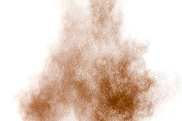 Brown dust explosion cloud.Brown particles splatter on white background.