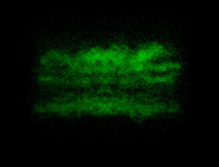 Green color powder explosion cloud on black background.Green dust splash.