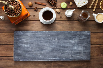 cup of coffee and beans on wooden background