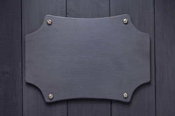 nameplate at black wooden background texture