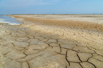 The dry soil of an old salt sea under the blue sky
