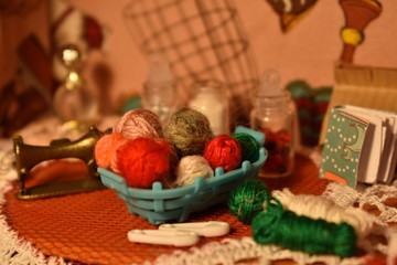Obraz na płótnie Canvas Workplace of dressmaker dolls. Miniature toy room of seamstress. Small sewing tools and accessories.