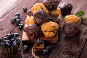 Blueberry and chocolate muffins on wooden background