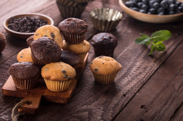 Blueberry and chocolate muffins on wooden background