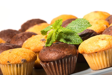 Assorted fresh delicious muffins isolated on white background