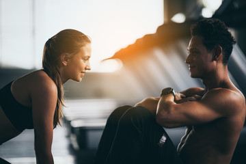 Fitness couple - woman and man in sport gym