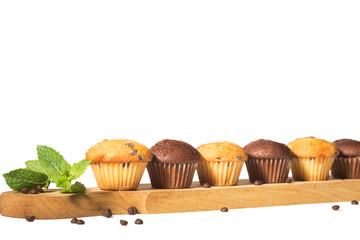Assorted fresh delicious muffins isolated on white background