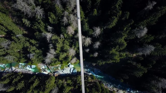 Drone voew from above over a forest with a suspension brodge.  H&auml;ngebr&uuml;cke F&uuml;rgangen M&uuml;hlebach Switserland 