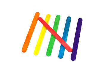 Popsicle sticks rainbow color isolated white background - LGBT pride flag patterns include of Lesbian, gay, bisexual, and transgender flag of LGBT organization.