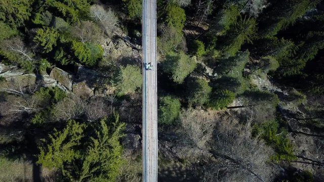 Drone voew from above over a forest with a suspension brodge.  H&auml;ngebr&uuml;cke F&uuml;rgangen M&uuml;hlebach Switserland 