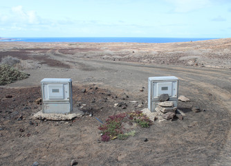 2 electricity meters seem abandoned in a moon-like landscape on La Graciosa Island (Lanzarote...