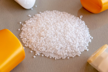 Close-up of plastic polymer granules and plastic bottle. Polymer pellets. polymer plastic. compound...