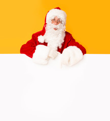 Santa Claus with big blank banner on orange background