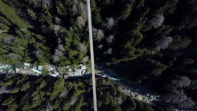 Drone voew from above over a forest with a suspension brodge.  H&auml;ngebr&uuml;cke F&uuml;rgangen M&uuml;hlebach Switserland 
