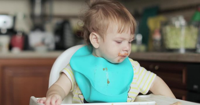 Infant boy eats meat