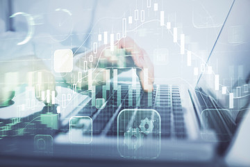 Double exposure of market chart with man working on computer on background. Concept of financial analysis.