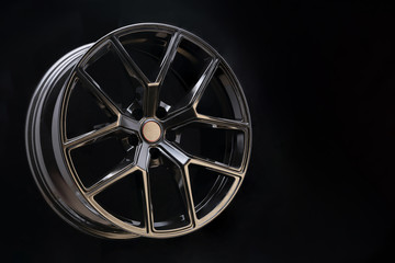 beautiful and cool aluminum forged wheel, close-up. dark on black background, copyspace. sports...