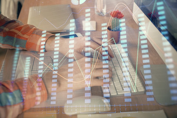 Double exposure of stock market chart with man working on computer on background. Concept of financial analysis.