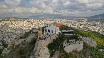 Aerial video of landmark chapel of Saint George on top of Lycabettus hill with beautiful sky and clouds, Athens, Attica, Greece
