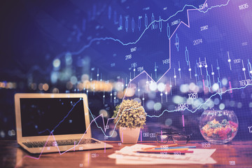 Forex graph hologram on table with computer background. Double exposure. Concept of financial markets.