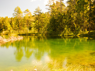 Fototapeta premium landscape with bright green lake and colorful trees, beautiful summer day, wonderful reflections in the water