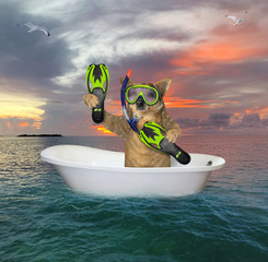 The beige dog diver with a mask, a snorkel and flippers is drifting in a bathtub in the open sea.