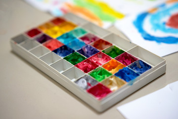 multiple color palette for art work of kid or artist on workspace table