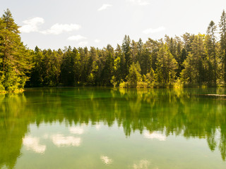  landscape with bright green lake and colorful trees, beautiful summer day, wonderful reflections in the water